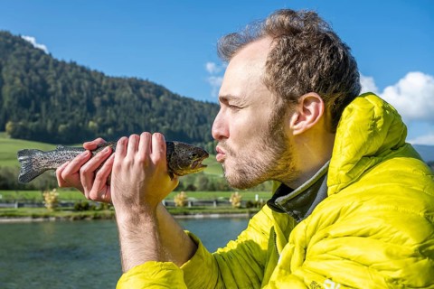 Man kisses caught trout