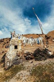 Tibetan Buddhist prayer flags lungta with Om mani padme hum mantra written on them in Spiti Valley in Himalayas