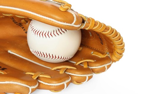 Baseball catcher mitt with ball isolated on white background close up