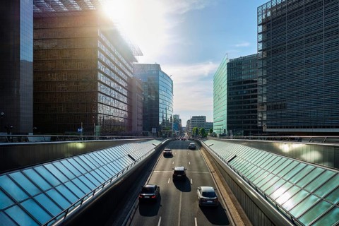 Street traffic in Brussels near European Commission building on sunset Rue de la Loi