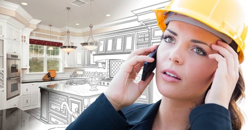 Concerned female contractor using smart phone over kitchen drawing gradating to photo