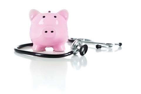 Piggy bank and stethoscope isolated on a white background