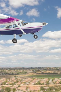 The cessna 172 single propeller airplane flying in the sky