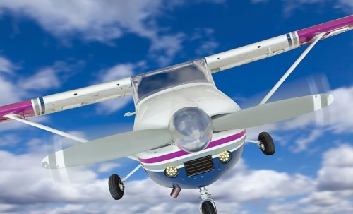 The front of A cessna 172 single propeller airplane in the sky