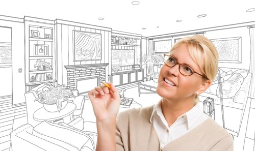 Woman with pencil over custom living room design drawing
