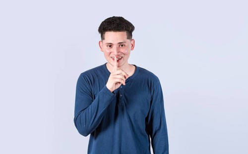 Man gesturing keep quiet