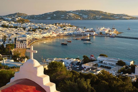 View of Mykonos town Greek tourist holiday vacation destination with famous windmills
