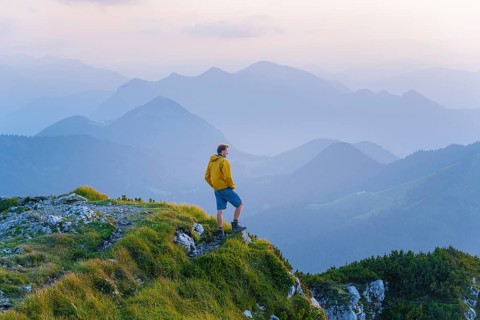 Hikers at the summit of the Benediktenwand at sunset