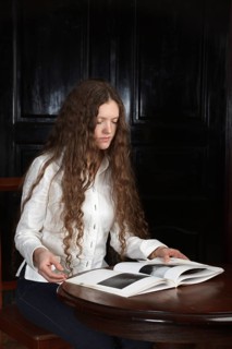Young beautiful woman with long hairsreading a book