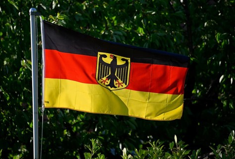 German flag with federal eagle on flagpole