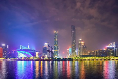 Guangzhou cityscape skyline over the Pearl River illuminated in the evening. Guangzhou