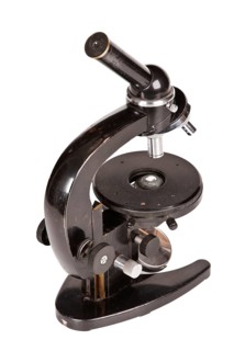 Old microscope isolated on white background