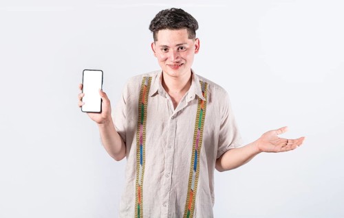 Handsome man smiling positive showing mobile phone blank screen with another hand palm open