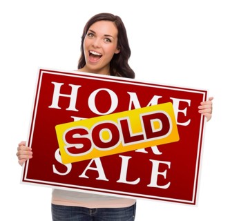Happy mixed-race female with sold home for sale real estate sign isolated on white
