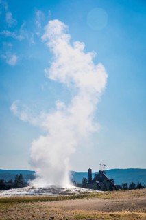 Old faithful geyser erupting at yellowstone national park