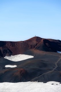Hikers in the distance on the volcanic crater of Magni volcano