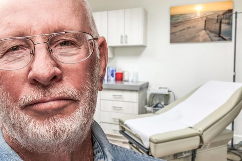 Worried senior adult man waiting in doctor office
