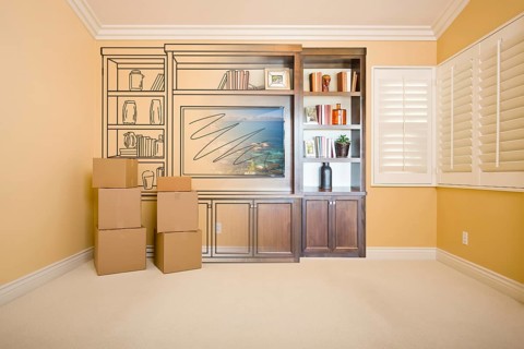 Moving boxes in room with entertainment unit drawing gradating to photograph