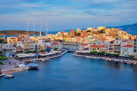 Beautiful Agios Nikolaos town on lake Voulismeni on sunset. Lasithi region of Crete island