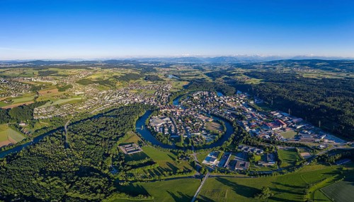 Aerial view of the town of Bremgarten and the meandering Reuss river in the Reuss valley of the canton of Aargau