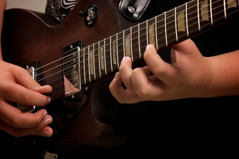 Musician plays his gibson les paul studio electric guitar