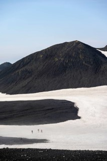 Hikers in the distance on a snow field