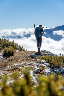Hiker looking over low clouds