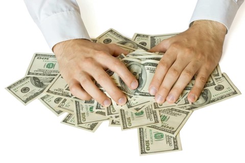 Greedy hands grabbing money lot of dollars
