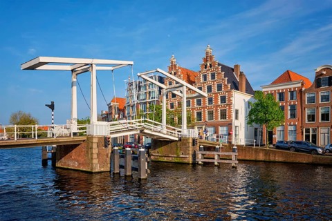 Gravestenenbrug bridge on Spaarne river and old houses in Haarlem