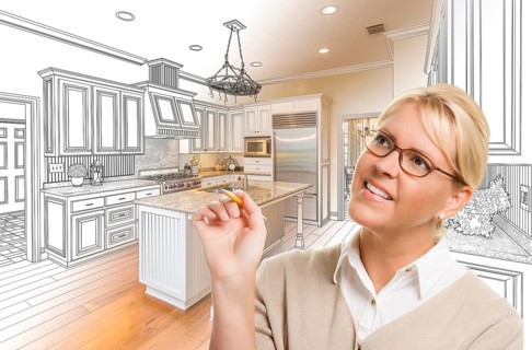 Creative woman with pencil over custom kitchen design drawing and photo combination