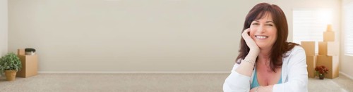 Banner of middle aged woman relaxing inside empty room with moving boxes