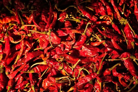 Dried dry red spicy chili peppers pile at asian market close up texture background Sardar Market