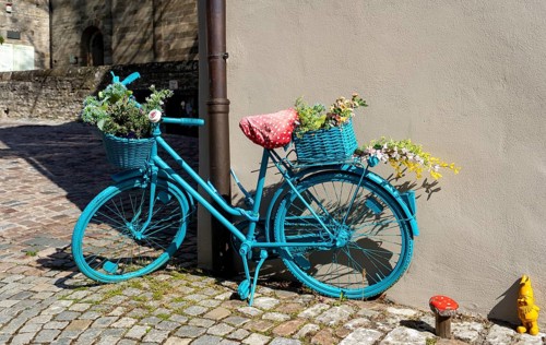 Old painted bicycle with flower decoration in an alley of the historic old town of the imperial palace Bad Wimpfen