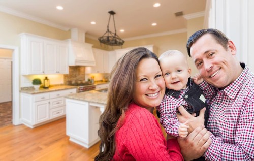 Young happy family inside beautiful custom kitchen