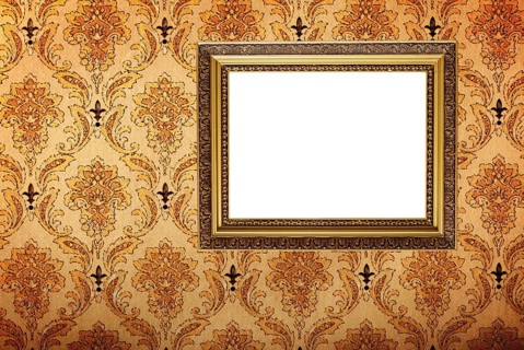 Vintage gold plated picture frame on retro wallpaper background