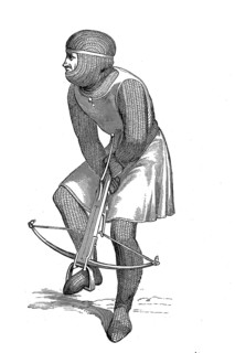 Crossbowman in the 13th century cocking his crossbow