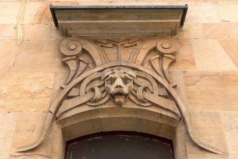 Art Nouveau ornaments with lion's head above an entrance door of a residential house