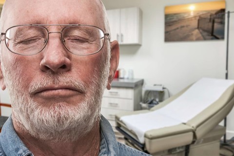 Worried senior adult man waiting in doctor office