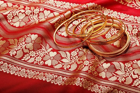 Indian sari with golden bangles clouse up