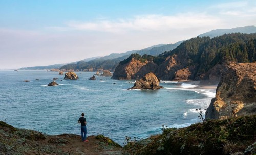 Young man standing on cliff