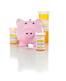 Piggy bank and non-proprietary medicine prescription bottles isolated on a white background