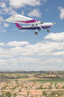 The cessna 172 single propeller airplane flying in the sky