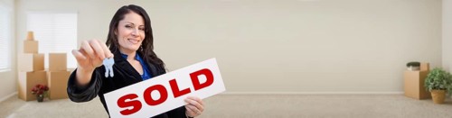 Banner of hispanic woman inside room with boxes holding house keys and sold for sale real estate sign