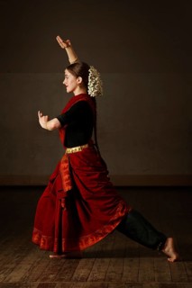 Young woman in sary dancing classical traditional indian dance Bharat Natyam