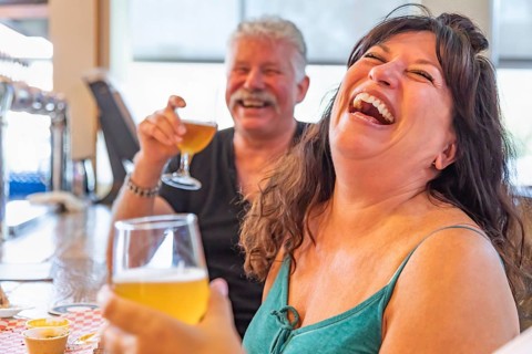 Group of friends enjoying glasses of micro brew beer at bar