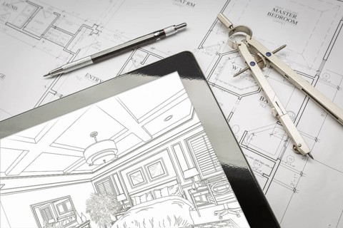 Computer tablet showing room illustration sitting on house plans with pencil and compass
