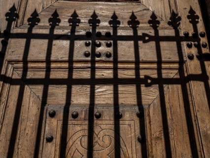 Shadow from a fence at the church gate
