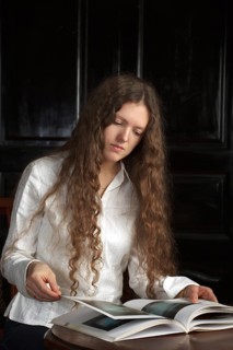 Young beautiful woman with long hairsreading a book