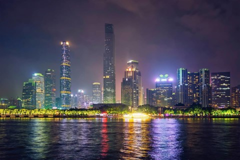 Guangzhou cityscape skyline over the Pearl River illuminated in the evening. Guangzhou
