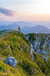 Hikers at the summit of the Benediktenwand at sunset